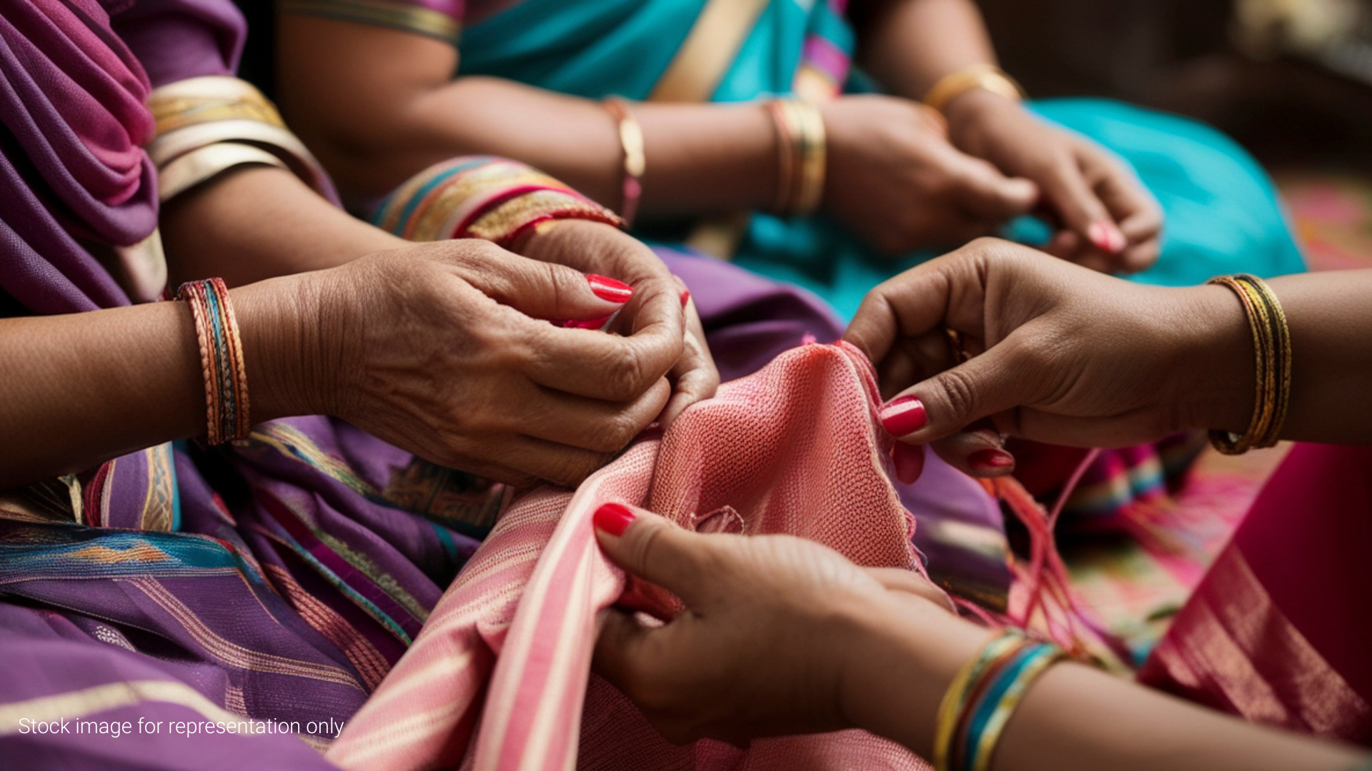 a stock image showing a close-up of women's hands working on embroidery